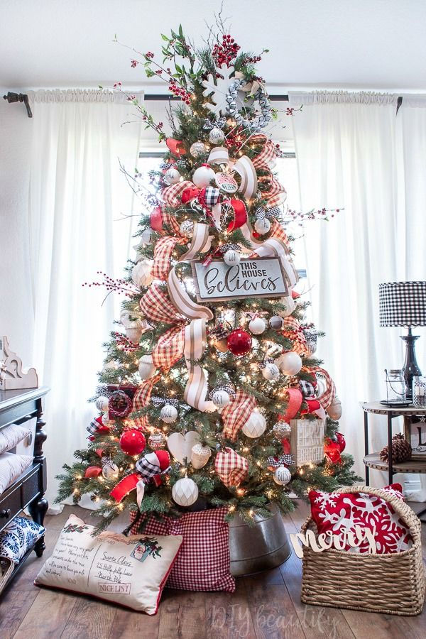 a christmas tree decorated with red, white and silver ornaments