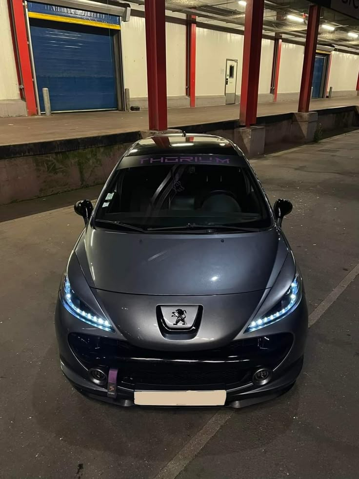 a silver sports car parked in front of a building