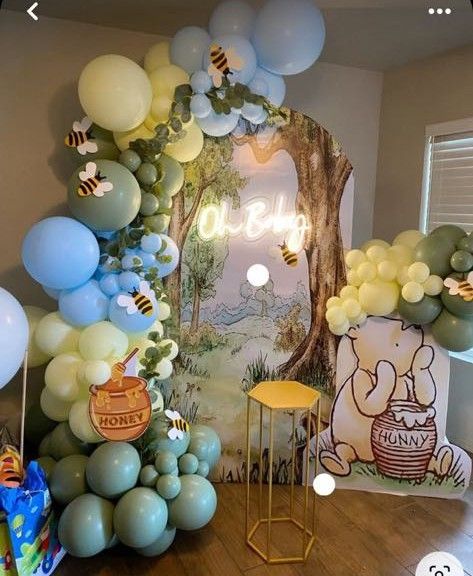 a room filled with balloons and winnie the pooh decorations