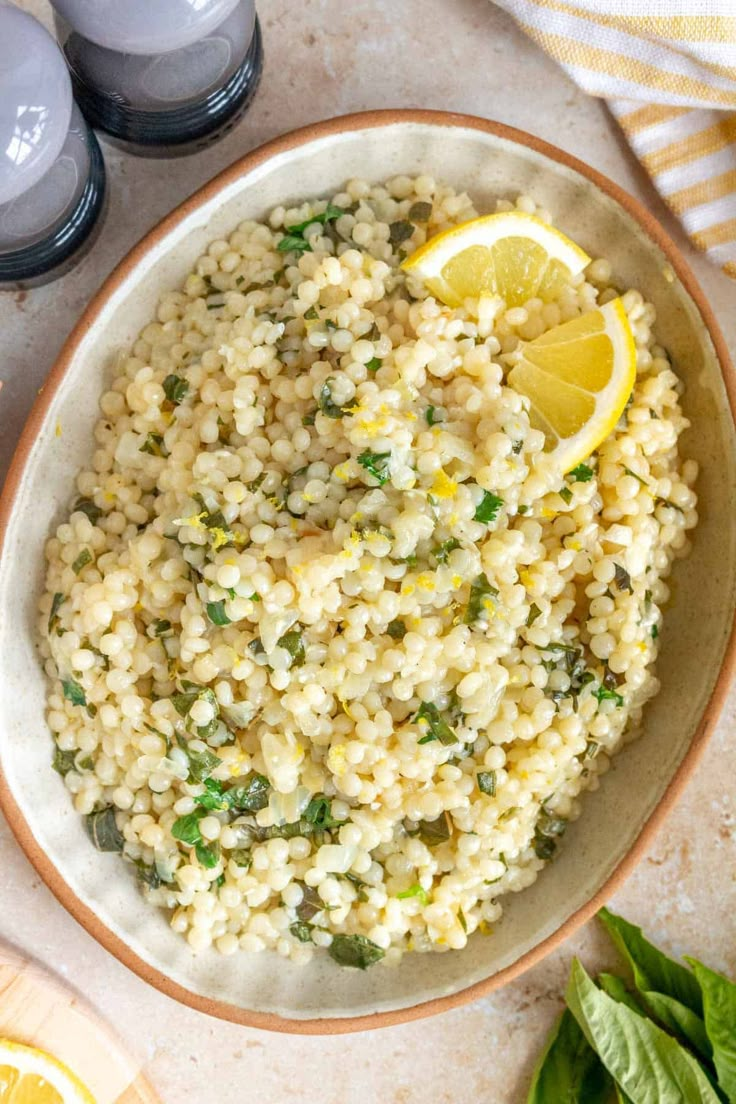 a bowl filled with rice, lemon and spinach