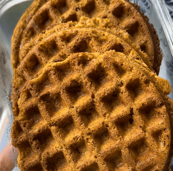 three waffles sitting on top of each other in a metal pan next to one another