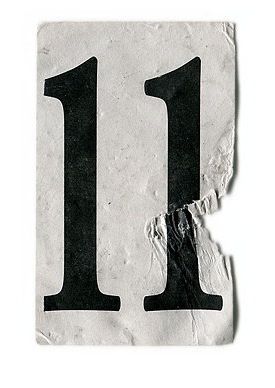 a white and black number one sticker on a piece of paper with torn edges