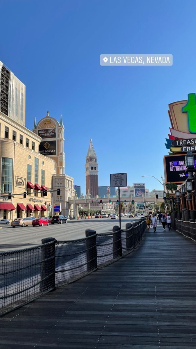 a city street with buildings and people walking on the side walk in las vegas, nevada