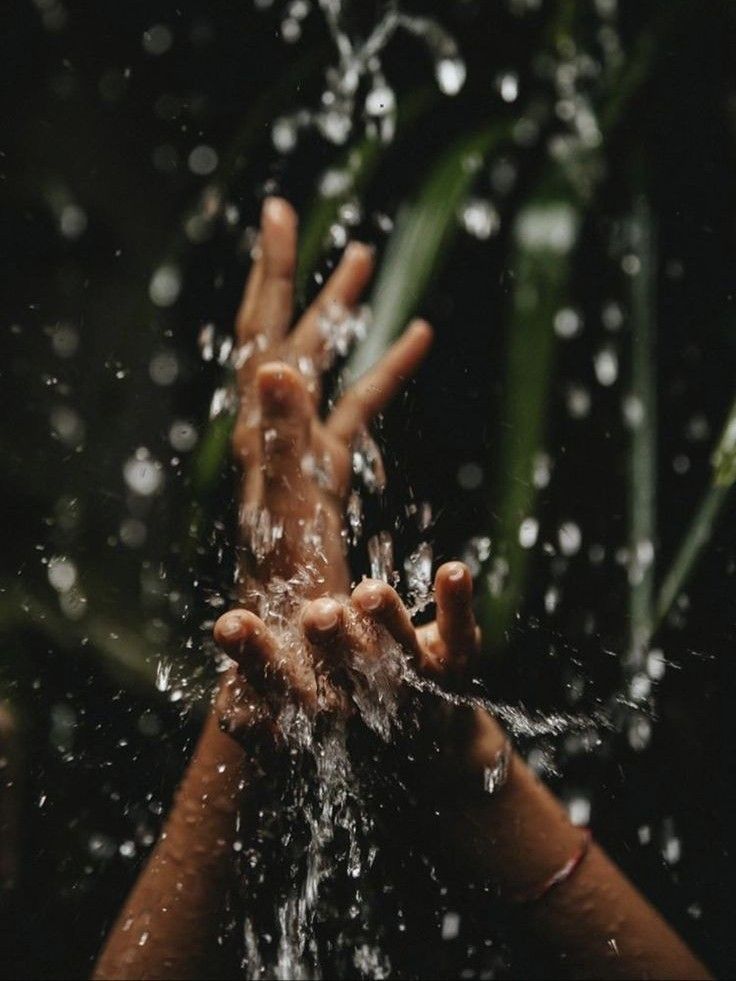 two hands reaching out from the water