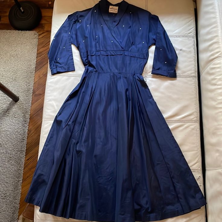 This Is A Great Vintage Dress With Rhinestones On The Top Of The Dress. There Is Shoulder Pads With Metal Snaps So You Can Take Them Off. No Belt. Unfortunately, There Is A White Stain On The Backside. And There Is Tiny Holes On Top Of Dress And Skirt. (See The Picture) Again This Is A Beautiful As Is Dress, Hope Someone Can Take Care. Waist 26" Waist To Bottom 31". Navy Blue Color (((((Please Please Consider Well Before You Purchase The Item. If You Have Any Questions, Please Do Not Hesitate To Ask Before Purchasing. I Am Not Happy With Bad Rating. Thank You! )))) Blue Cotton Retro Vintage Dress, I Am Not Happy, Dress With Rhinestones, Vintage Blue Button-up Dress, Vintage Blue Clip-on Earrings For Gift, White Stain, Rockabilly Dress, Navy Blue Color, Vintage Dress