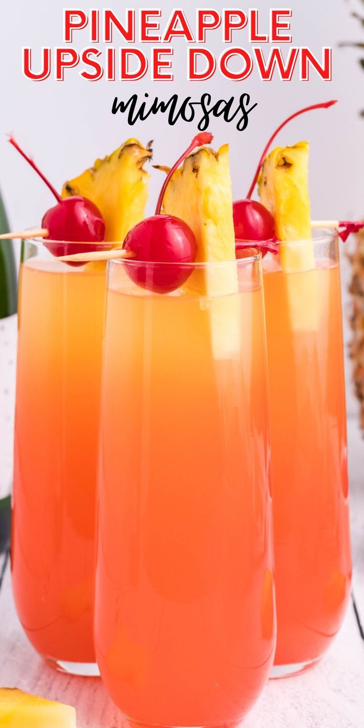 pineapple upside down drinks in glasses with cherries on the rim and pineapple