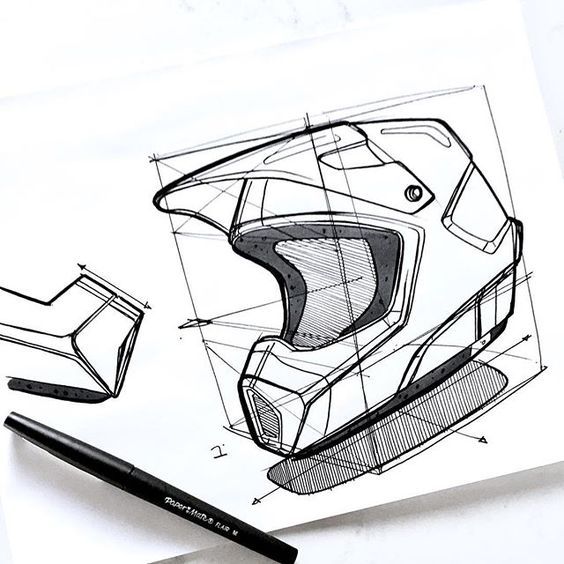 a drawing of a motorcycle helmet on top of a piece of paper next to a marker