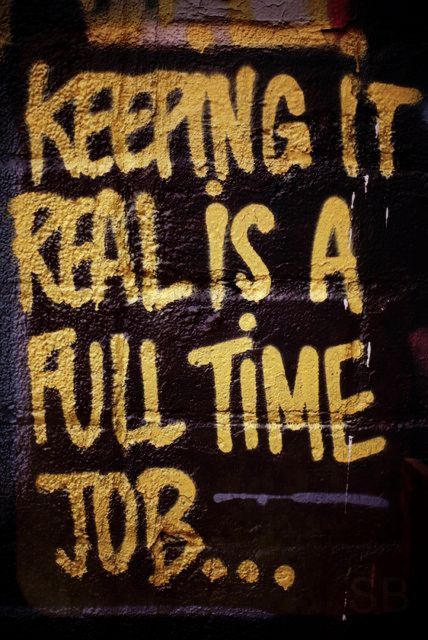 graffiti on the side of a building reads keeping it real is a full time job