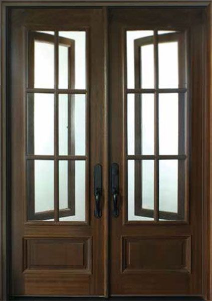 two wooden doors with glass panels and sidelights on the front of a house,