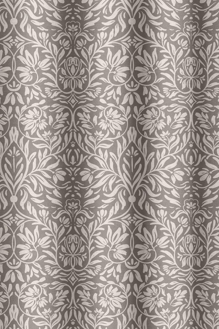 a gray and white shower curtain with an ornate design on the bottom half of it