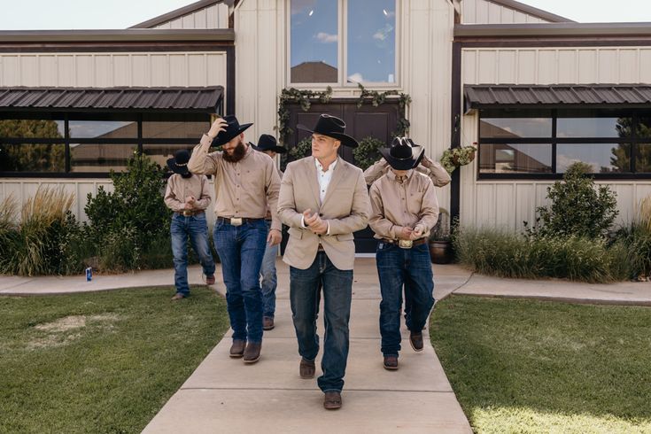 a group of men walking down a sidewalk