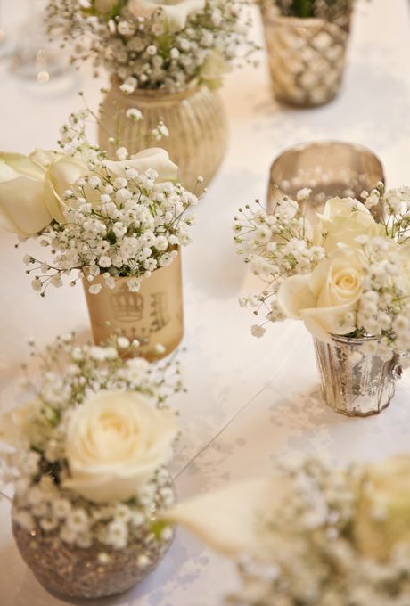 flowers in vases sitting on a table