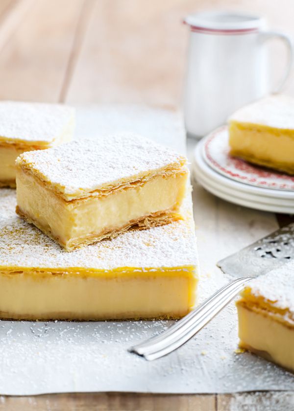 three pieces of cake sitting on top of a table next to a cup and fork