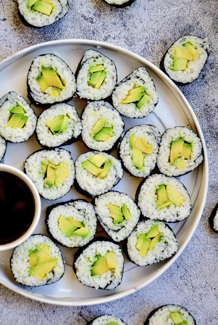 a plate with some sushi and a cup of coffee