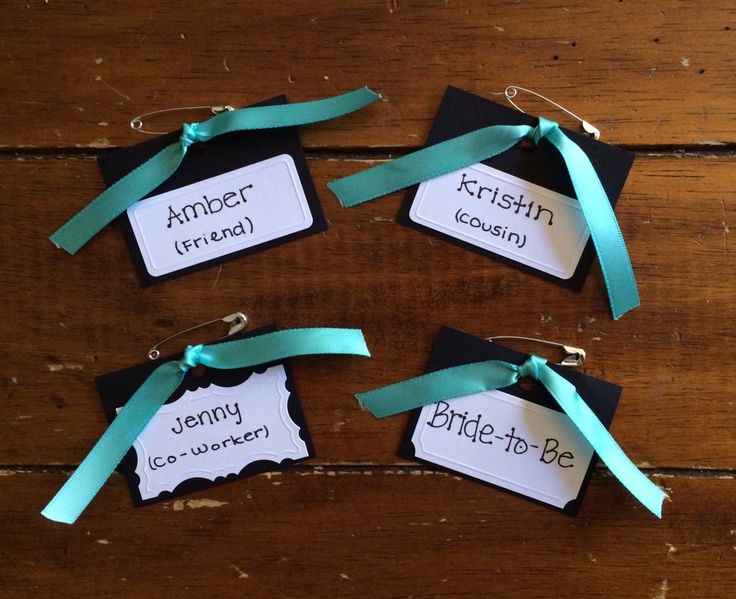 four tags with names and ribbons on them