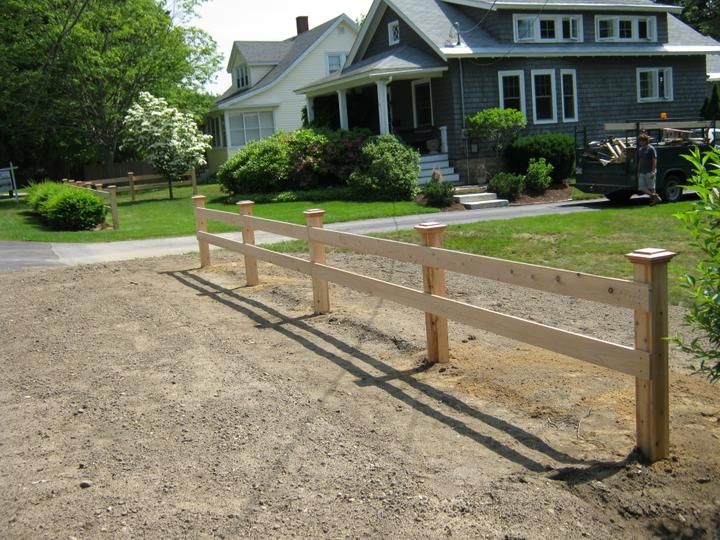 a wooden fence in front of a house