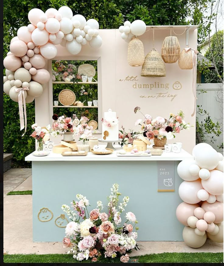 an ice cream stand decorated with balloons, flowers and desserts for a bridal party