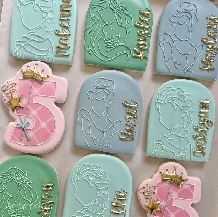 decorated cookies in the shape of princesses and tiaras