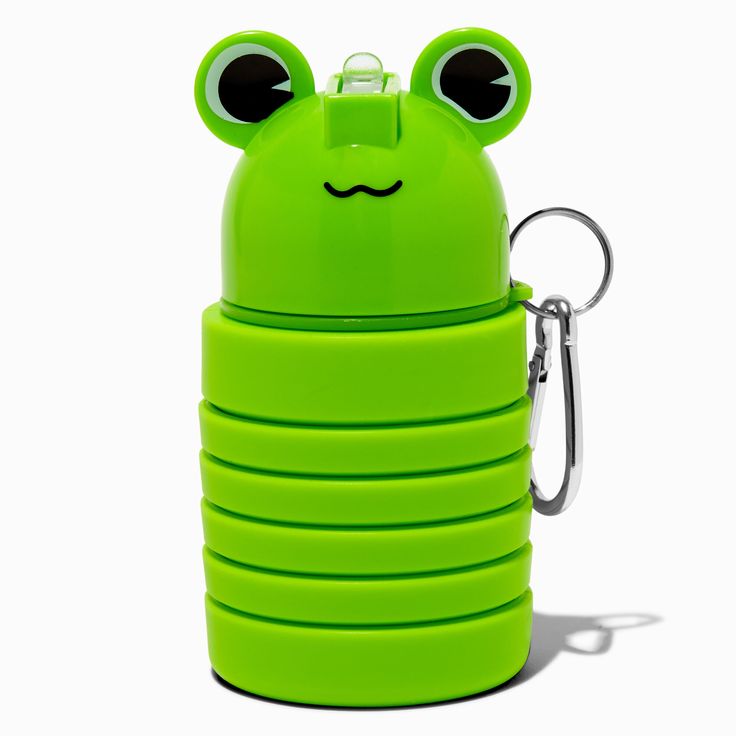 a green frog shaped water bottle with eyes on it's side and a keychain hanging from the front