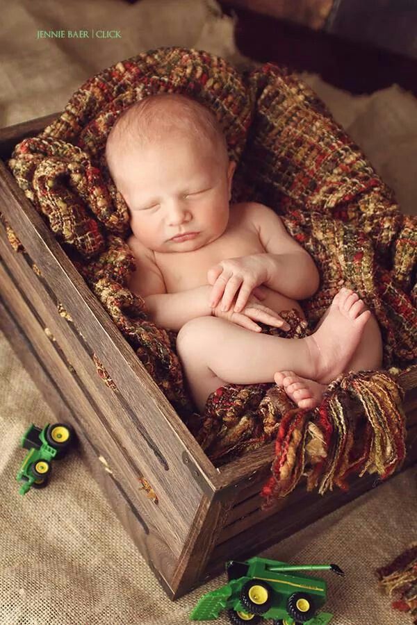 a baby is laying in a wooden box