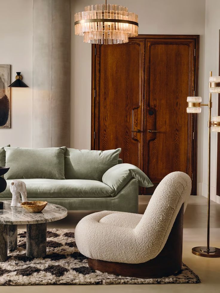 a living room filled with furniture and a chandelier