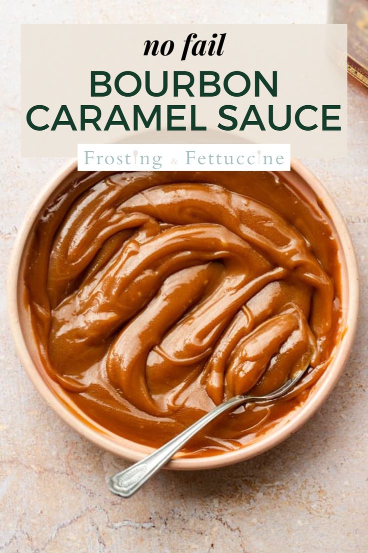 a bowl filled with caramel sauce on top of a table next to a spoon