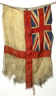 an old british flag hanging on a clothes line