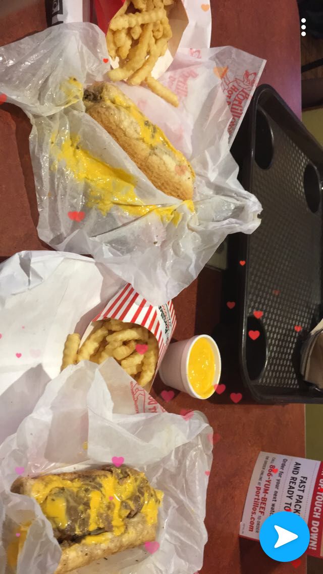 two hot dogs and some fries on a table