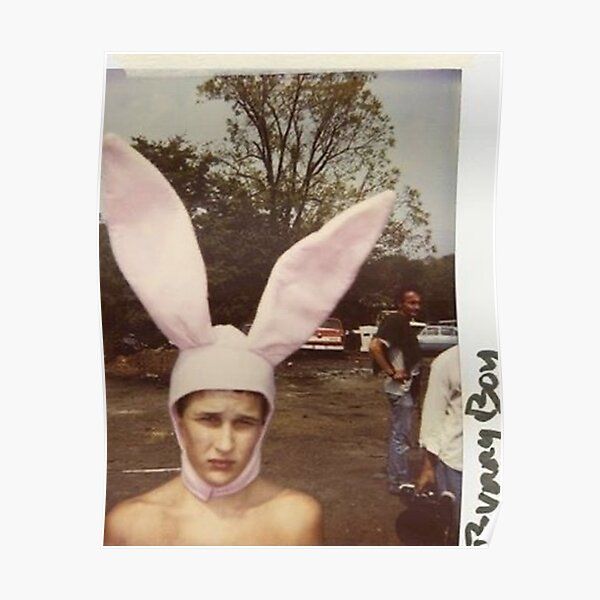 a young man wearing a pink bunny ears hat