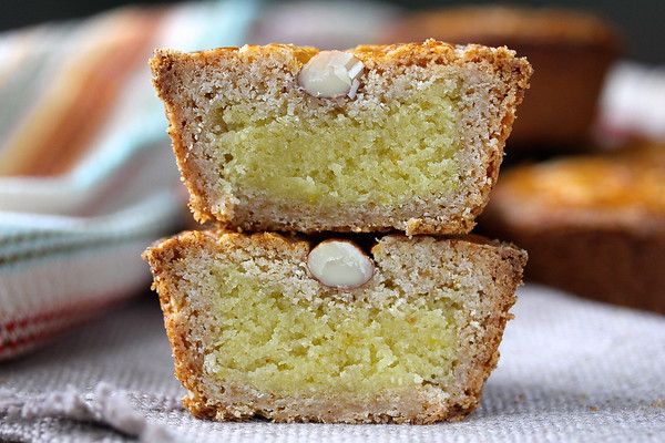 two pieces of cake sitting next to each other on top of a cloth covered table