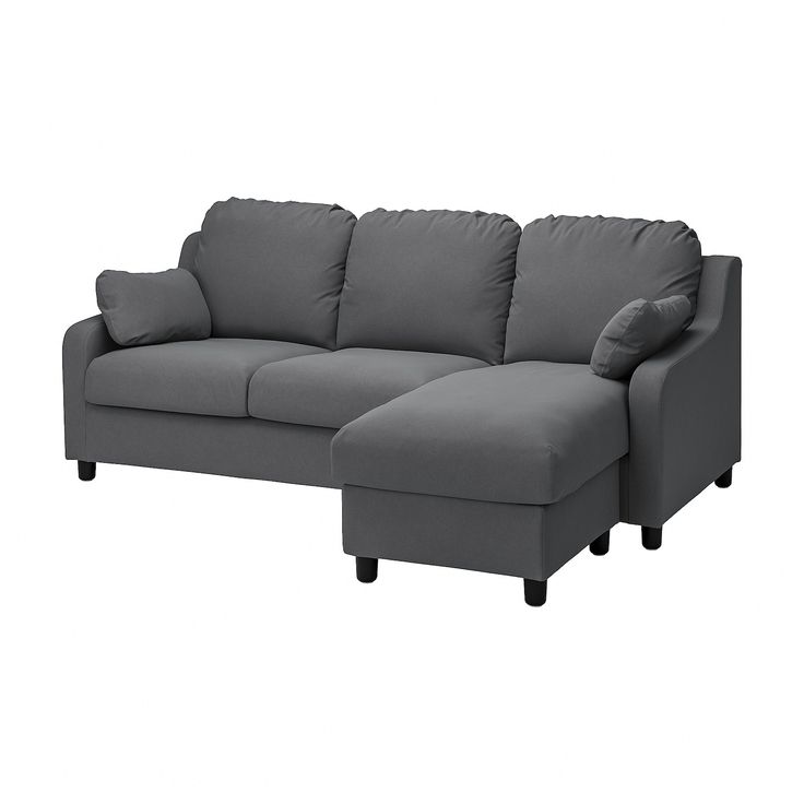 a gray couch sitting next to a white wall