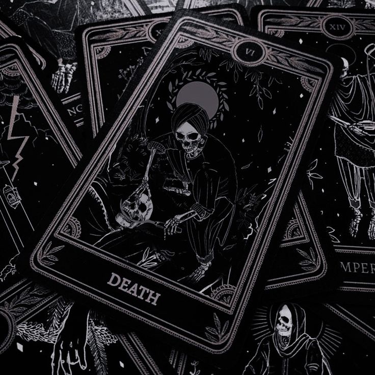 some black and gold playing cards with skeletons on them