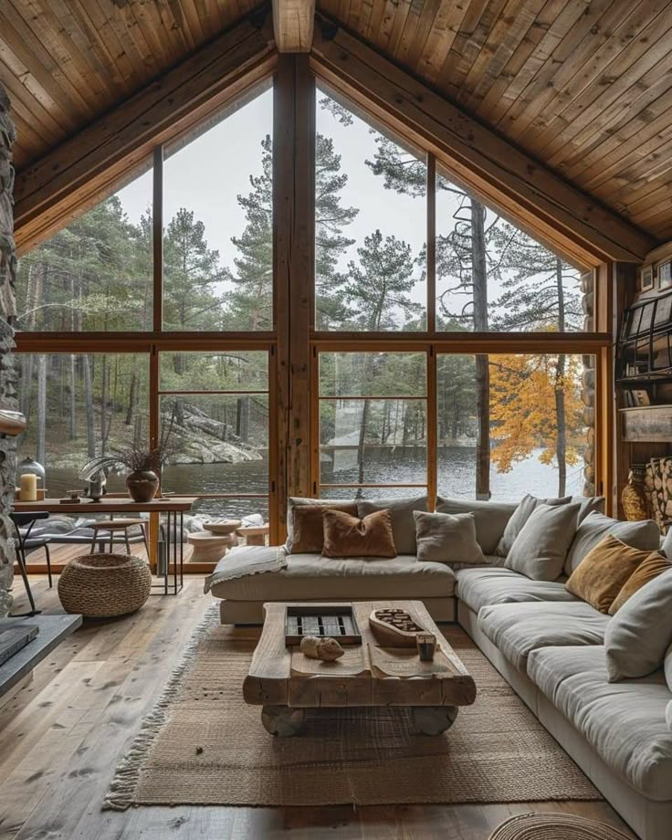 a living room filled with lots of furniture next to a large window covered in wood