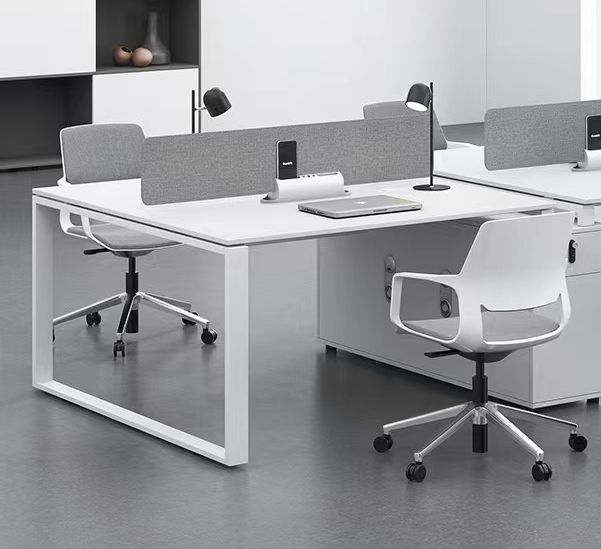 an office desk with two chairs and a laptop on it