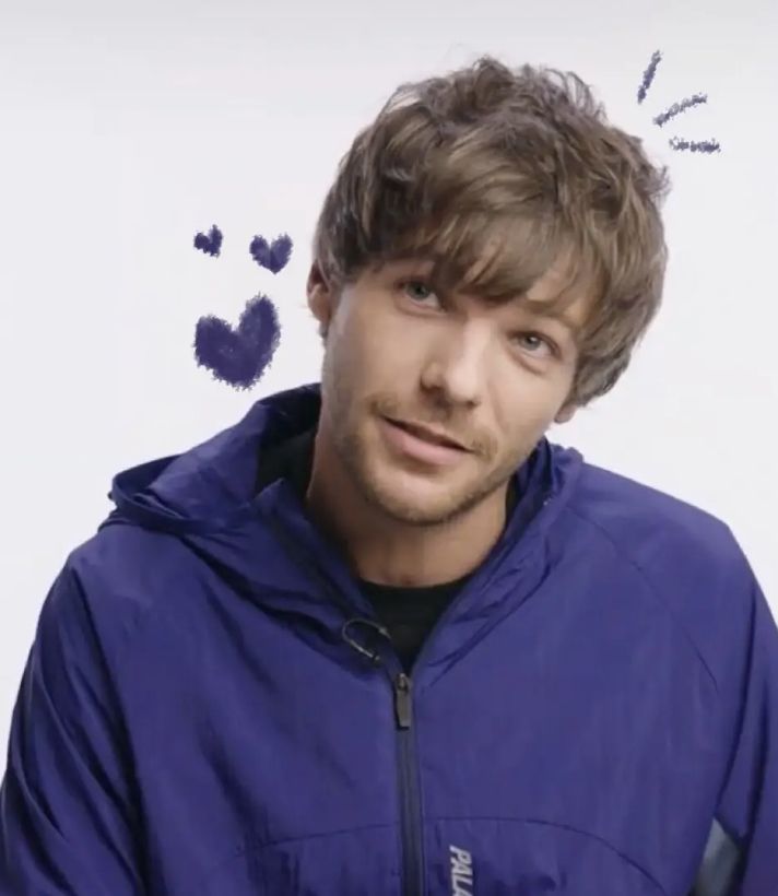 a young man in a blue jacket with hearts drawn on the wall behind his head