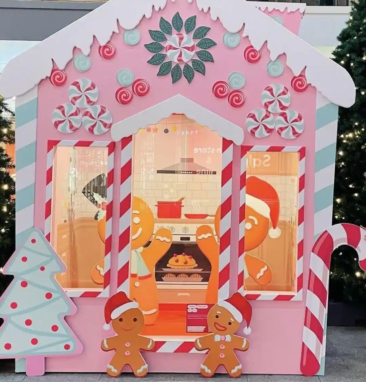 a gingerbread house is decorated with candy canes and snowflakes for the holiday season