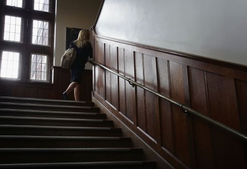 a woman is walking up some stairs