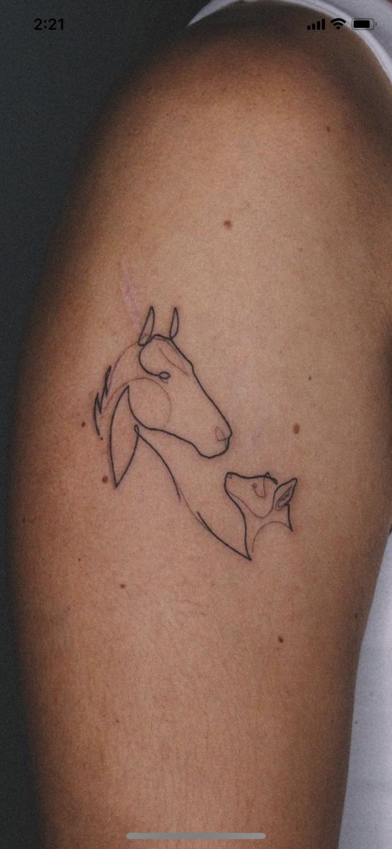 a woman's arm with a horse tattoo on the left side of her body