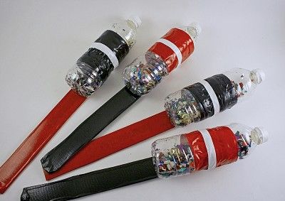 four red and black toothbrushes are lined up on a white surface with plastic wrap around them