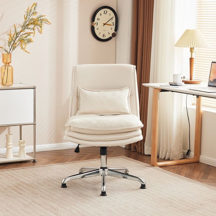 a white office chair sitting on top of a hard wood floor next to a window