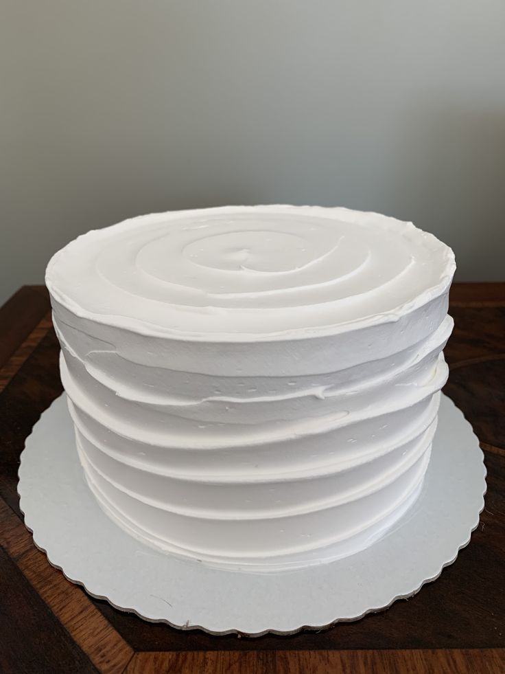 a stack of white cake sitting on top of a wooden table