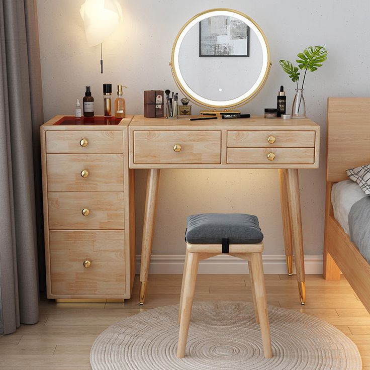 a bedroom scene with focus on the dressing table and stool, which has a round mirror above it