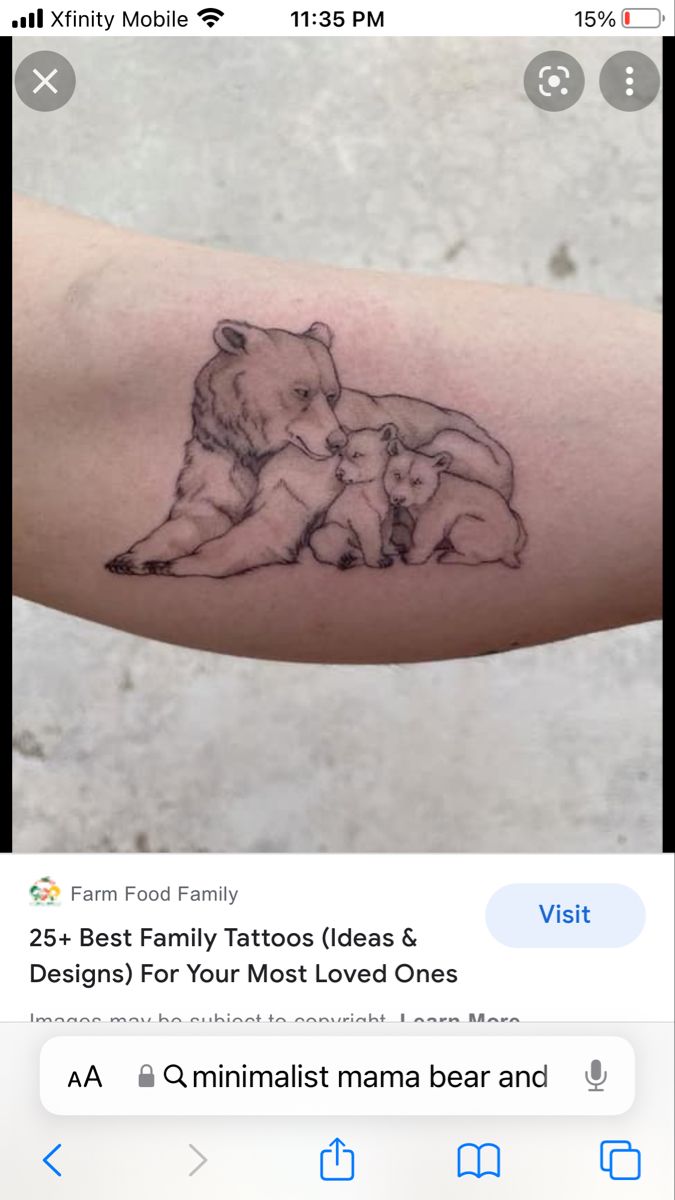 a tattoo on the arm of a woman with an image of a bear and her cub