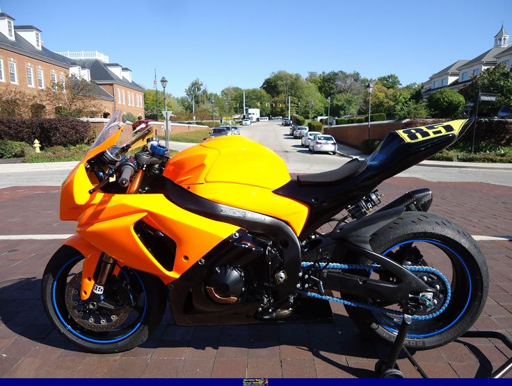 a yellow and black motorcycle parked on the street