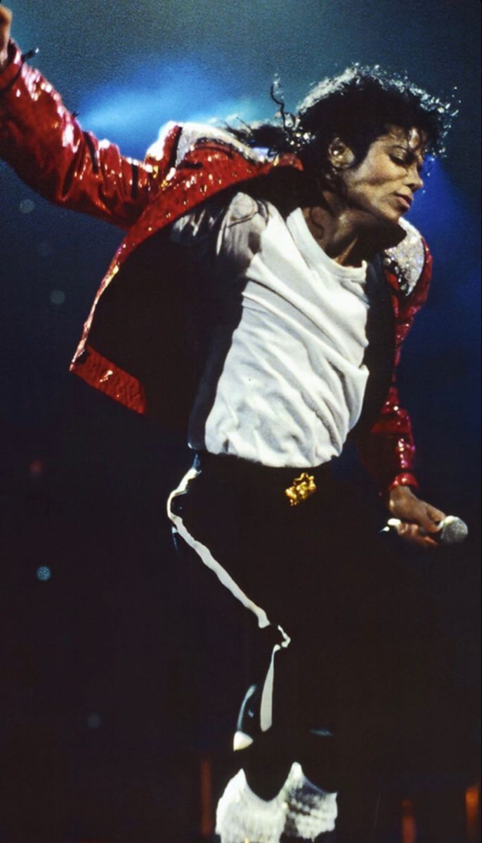 michael jackson performing on stage in his red jacket