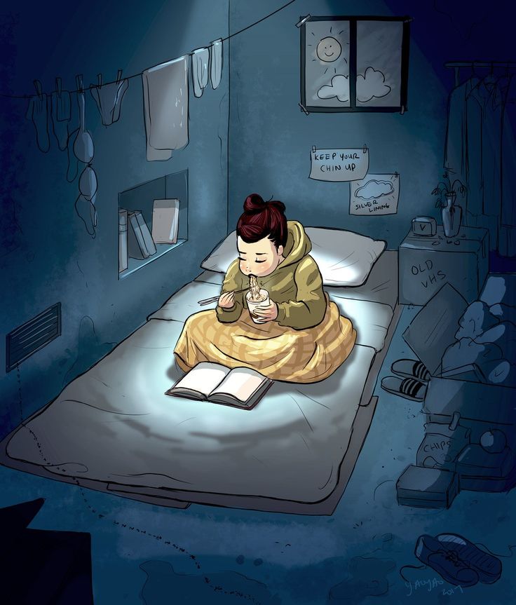 a person sitting on a bed reading a book