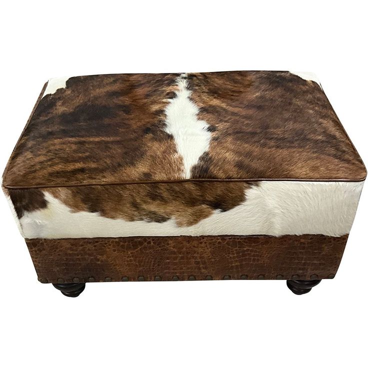 a brown and white cow hide ottoman