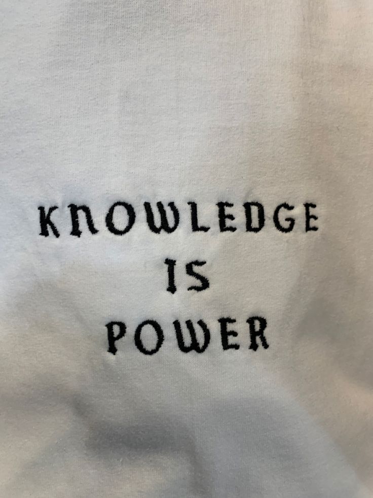 a white t - shirt with the words'knowledge is power'embroidered on it