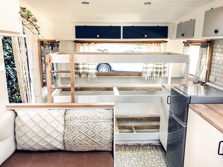 the interior of a camper that has been converted into a living room and kitchen