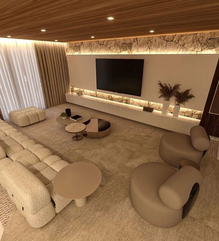 a living room filled with lots of furniture and a flat screen tv mounted to the wall